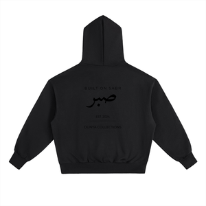 Back view of black Sabr oversized fleece hoodie with tonal Arabic calligraphy design