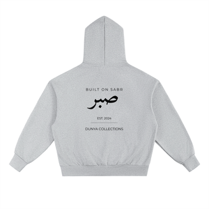 Back view of light grey Sabr oversized fleece hoodie with black Arabic calligraphy and Dunya Collections branding